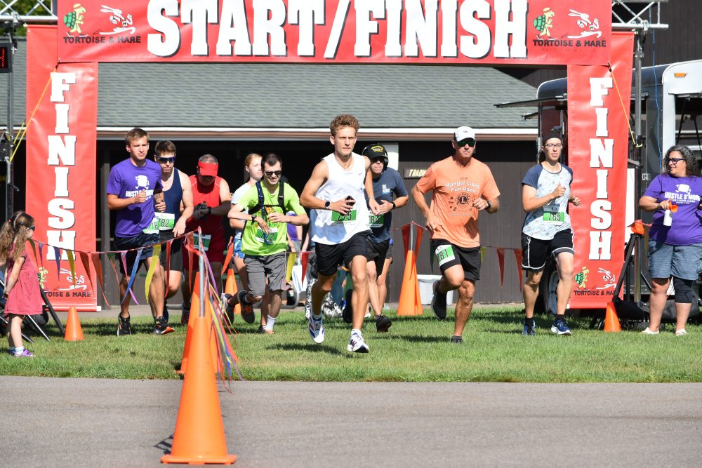 Group of runners starting the 10K race at the Hustle S'more for Lions Camp