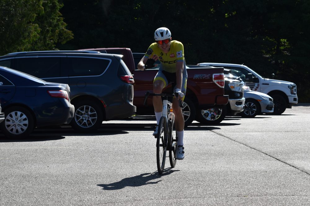 Biker finishing the 15 mile bike at the Hustle S'more for Lions Camp