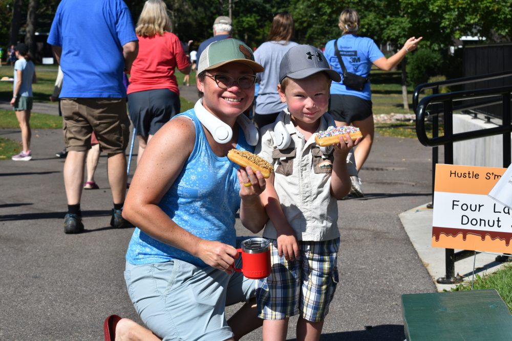 Participants with donuts at the Hustle S'more for Lions Camp event