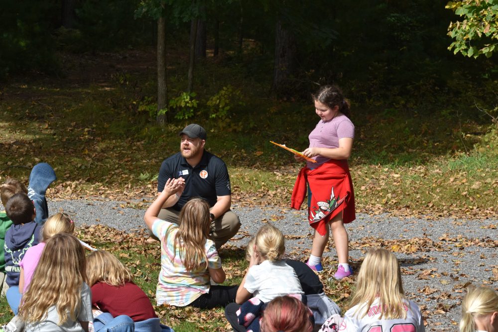 A student presents their observations to their class outside during a NASA DISCOVERIES Session.